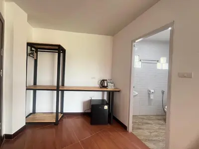 a bathroom with a sink and a shelf and a mirror at Lucky 9 Airport Hotel Phuket in Nai Yang Beach