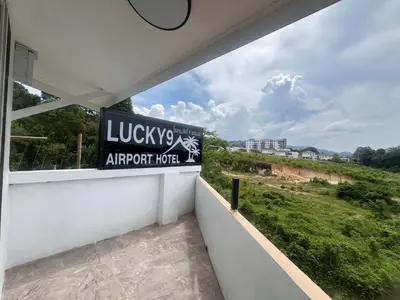 a balcony with a sign that reads lobby approved hotel at Lucky 9 Airport Hotel Phuket in Nai Yang Beach