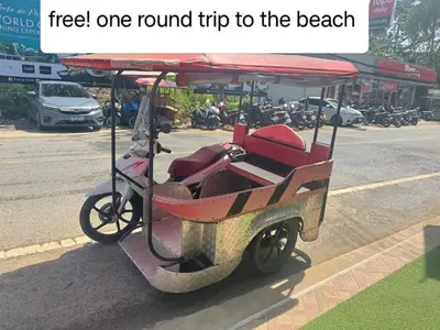 a golf cart parked on the side of the road at Lucky 9 Airport Hotel Phuket in Nai Yang Beach
