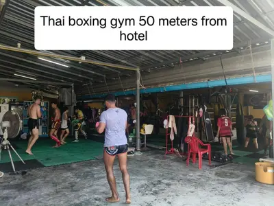 a man standing in a gym with a group of people at Lucky 9 Airport Hotel Phuket in Nai Yang Beach