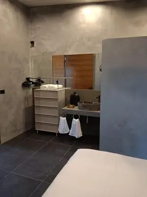 a kitchen with a sink and a counter with towels at Sakhu Art Villa in Nai Yang Beach