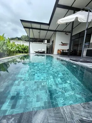 a swimming pool in the middle of a house at Sakhu Art Villa in Nai Yang Beach