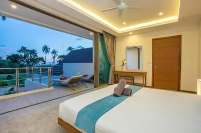 a bedroom with a large bed and a balcony at Private Pool 4BR Villa Kari next to Rawai Beach in Rawai Beach