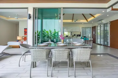 a dining room with a table and chairs at Private Pool 4BR Villa Kari next to Rawai Beach in Rawai Beach