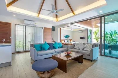 a living room with a couch and a table at Private Pool 4BR Villa Kari next to Rawai Beach in Rawai Beach