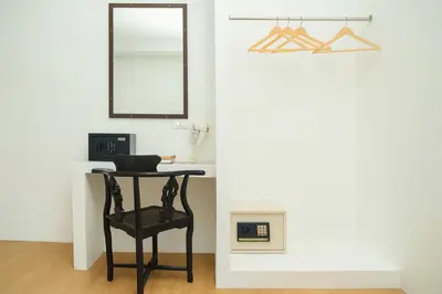 a table with a chair and a mirror in a room at Chic Boutique Hotel, Patong in Patong Beach