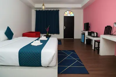 a hotel room with a large bed and a kitchen at Chic Boutique Hotel, Patong in Patong Beach