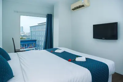 a hotel room with a bed and a window at Chic Boutique Hotel, Patong in Patong Beach
