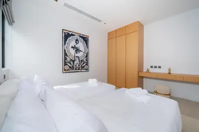 a bedroom with two white beds and a wooden cabinet at Villa Beautiful swimming pool in Phuket
