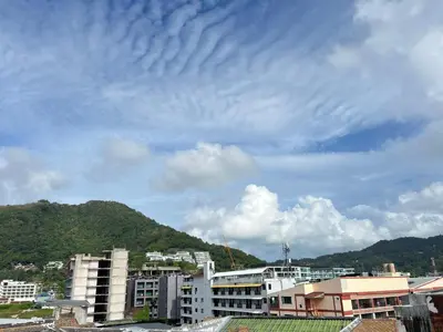 a city skyline with buildings and a cloudy sky at The Sealect Hotel in Kata Beach