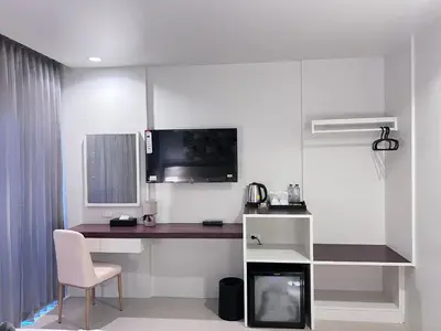 a white room with a desk and a computer in it at The Sealect Hotel in Kata Beach