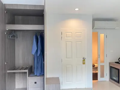 a closet with a white door in a room at The Sealect Hotel in Kata Beach
