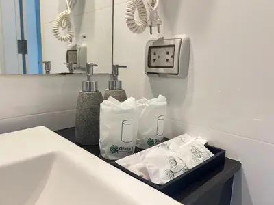 a bathroom with a sink and a mirror at The Sealect Hotel in Kata Beach