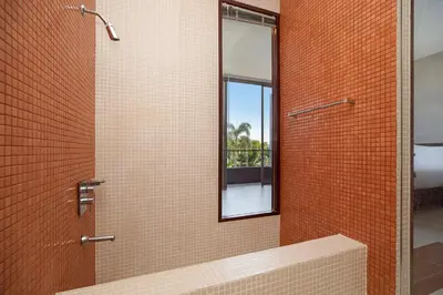 a bathroom with a shower with a mirror at 3BR Pool Access Villa near Mission Hills Golf - Argent 7 in Ban Muang Mai