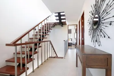 a staircase in a house with a desk and a clock at 3BR Pool Access Villa near Mission Hills Golf - Argent 7 in Ban Muang Mai