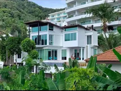 a large white building with trees in front of it at Villa Beverly Private Infinity Pool with Seaview near Kata Beach in Kata Beach