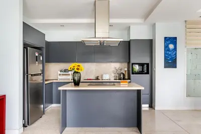 a kitchen with a counter with a vase of flowers on it at Villa Beverly Private Infinity Pool with Seaview near Kata Beach in Kata Beach