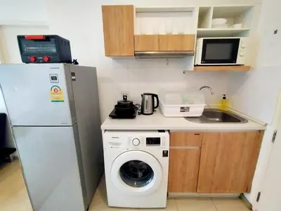 a small kitchen with a washing machine and a washer at Cozy room near beaches & restaurants in Bang Tao Beach