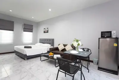 a bedroom with a bed and a table and a couch at Siam Condo Apartment, 600 metters to Bang Tao beach in Surin Beach