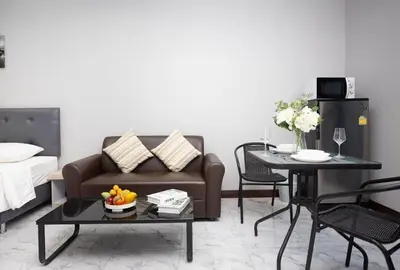 a living room with a couch and a table at Siam Condo Apartment, 600 metters to Bang Tao beach in Surin Beach
