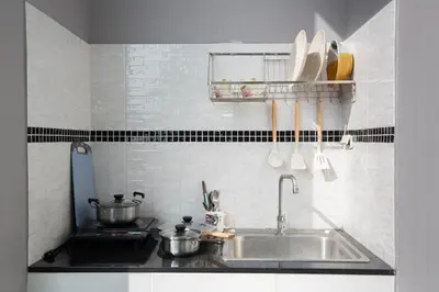 a kitchen counter with pots and pans and a sink at Siam Condo Apartment, 600 metters to Bang Tao beach in Surin Beach
