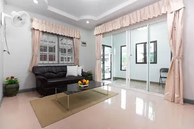 a living room with a couch and a table at SIRI apartments Bangtao beach in Ban Thalat Choeng Thale