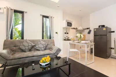 a living room with a couch and a table at SOMAN apartments Bang-Tao beach in Phuket Town