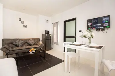a living room with a couch and a table at SOMAN apartments Bang-Tao beach in Phuket Town