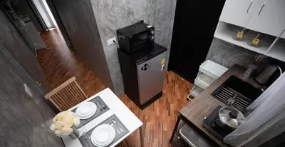 an overhead view of a kitchen with a small refrigerator at Sam's Unique and Stylish houses, 10 min to the beach in Ban Thalat Choeng Thale