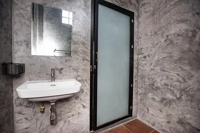 a bathroom with a sink and a mirror at Sam's Unique and Stylish houses, 10 min to the beach in Ban Thalat Choeng Thale