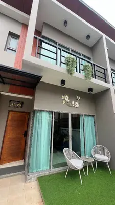 a house with two chairs and a table in front of it at Stylish Family Townhouse 3 Bdr in Chalong