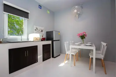 a kitchen with a table and a refrigerator at Tutu house, walking distanse to Bang Tao beach in Bang Tao Beach