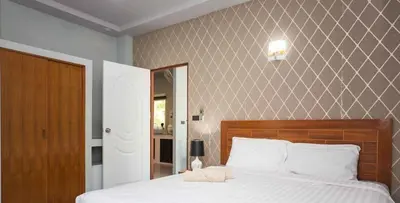 a bedroom with a large bed with white sheets at Tutu house, walking distanse to Bang Tao beach in Bang Tao Beach