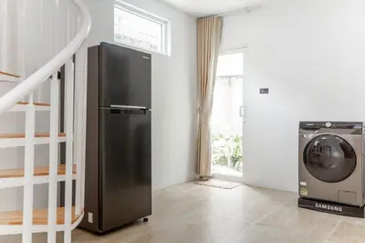 a black refrigerator and a washing machine in a room at Japanese houses in Phuket in Ban Thalat Choeng Thale