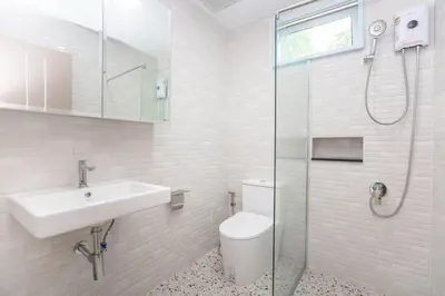 a bathroom with a sink and a toilet and a shower at Japanese houses in Phuket in Ban Thalat Choeng Thale