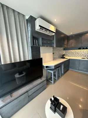 a kitchen with a table and a counter top at CityGate Kamala 1 bedroom By Ere L309 in Kamala Beach