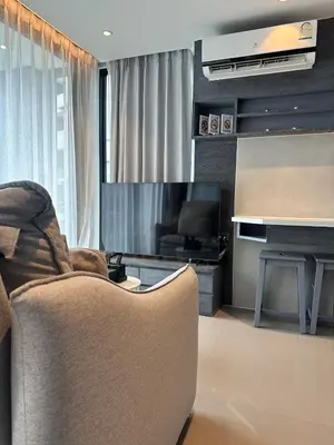 a living room with a couch and a flat screen tv at CityGate Kamala 1 bedroom By Ere L309 in Kamala Beach