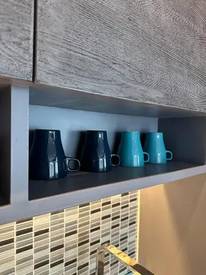 a row of blue cups sitting on a shelf at CityGate Kamala 1 bedroom By Ere L309 in Kamala Beach