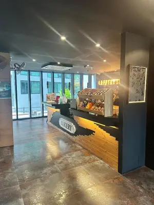 a restaurant with a counter with food on it at CityGate Kamala 1 bedroom by Ere L807 in Kamala Beach