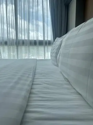 a bed in a room with a large window at CityGate Kamala 1 bedroom by Ere L807 in Kamala Beach
