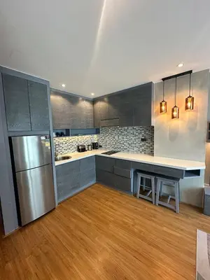 a kitchen with stainless steel appliances and wood floors at CityGate Kamala 1 bedroom by Ere L807 in Kamala Beach