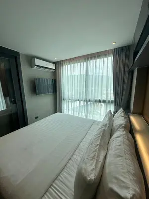 a large bed in a bedroom with a window at CityGate Kamala 1 bedroom by Ere L807 in Kamala Beach
