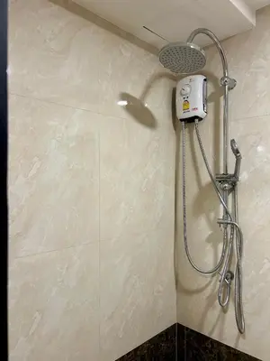 a shower with a shower head in a bathroom at Hillside-Seashore Space Mai Khao Beach in Mai Khao Beach