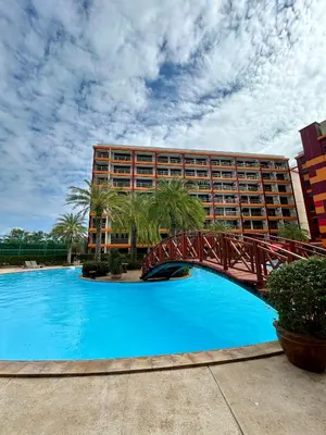 a bridge over a swimming pool in front of a hotel at Hillside-Seashore Space Mai Khao Beach in Mai Khao Beach