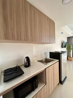 a small kitchen with a sink and a microwave at Hillside-Seashore Space Mai Khao Beach in Mai Khao Beach