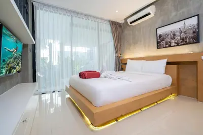 a bedroom with a large bed with a large window at Duplex Villa Natural Touch A2 2BR with scenic view and rooftop terrace in Kamala Beach