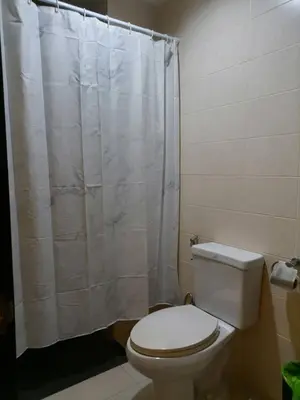 a bathroom with a toilet and a shower curtain at AtWhitePatong in Patong Beach