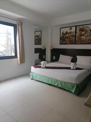 a bedroom with a large bed and a window at AtWhitePatong in Patong Beach