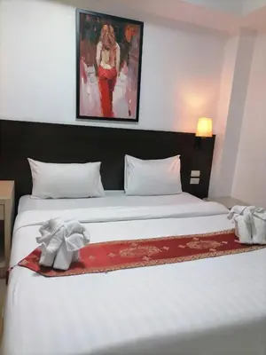 a bedroom with a bed with two stuffed elephants on it at AtWhitePatong in Patong Beach