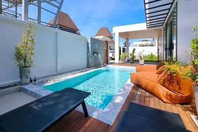 a swimming pool in the backyard of a house at Phirunda Pool Villas in Ban Suan